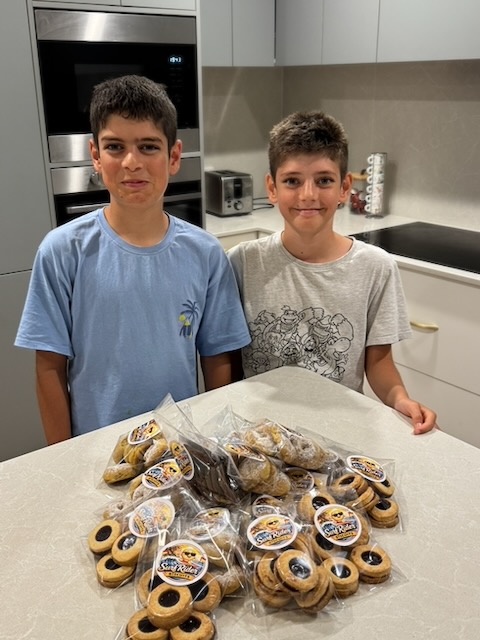Giacomo and Ricardo Scott in their kitchen with bags of freshly baked Surf Rider Biscuits